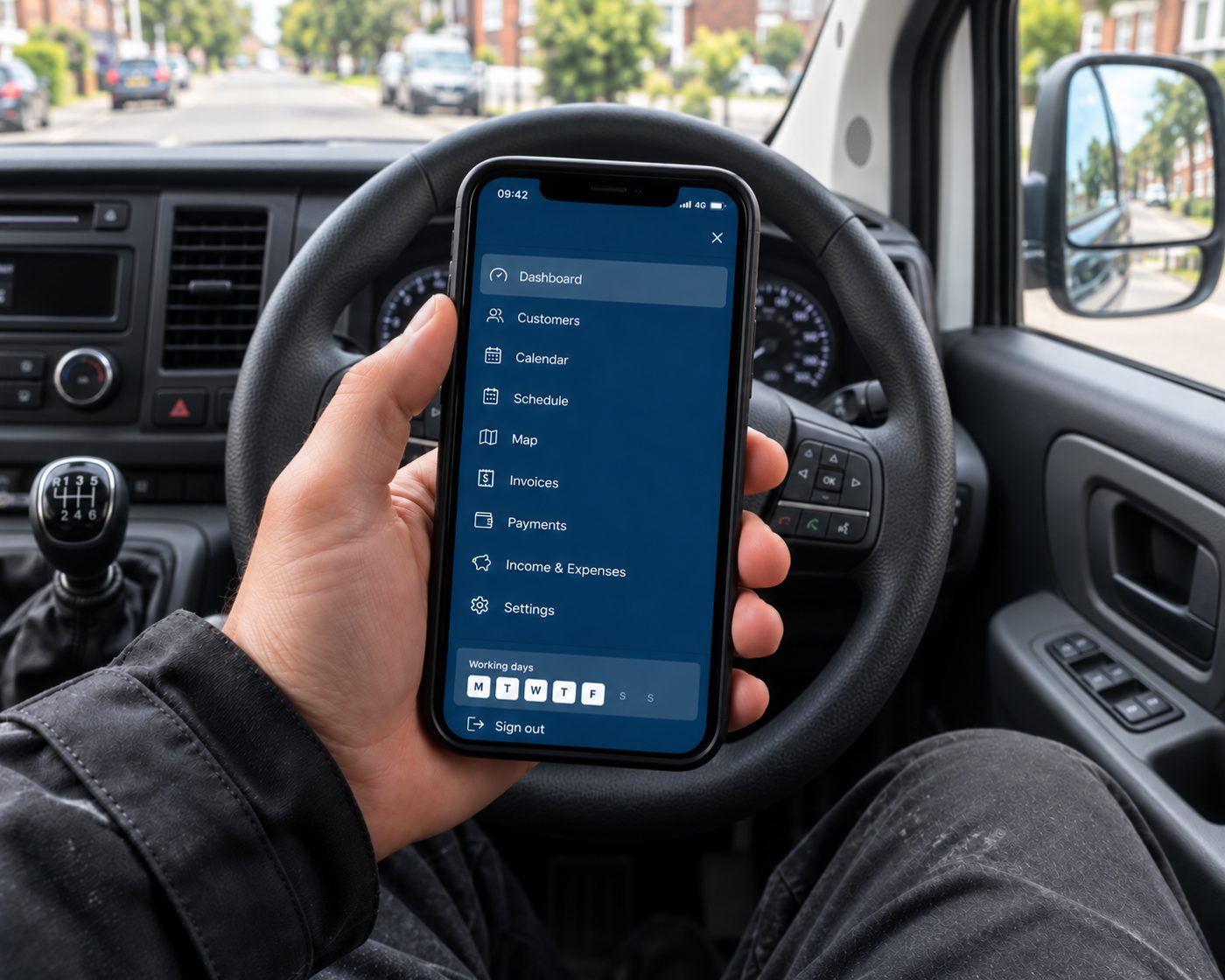 Window cleaner checking today's schedule on a phone in the van